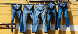 five blue denim jeans hanged on 
